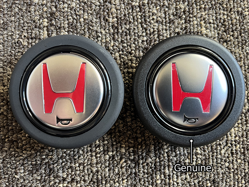 Comparison of genuine NSX 02R horn button and fake one (front side)